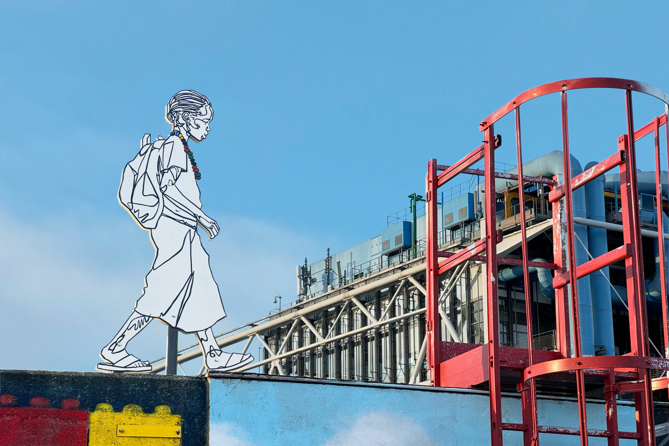 A white outline of a girl walking on a wall